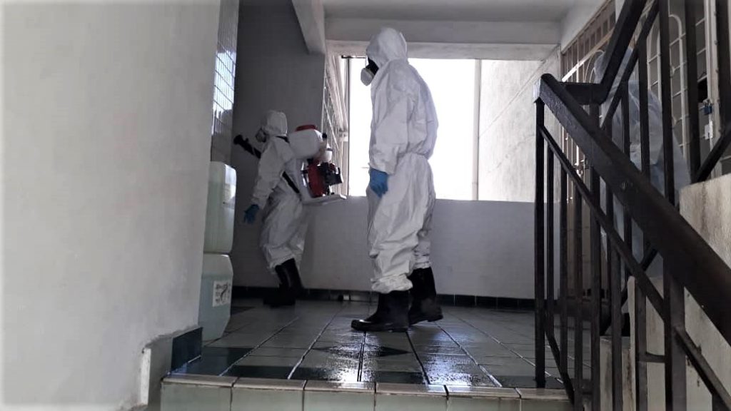 Workers sanitising the lifts and staircase in Goodyear Court 10 earlier today.