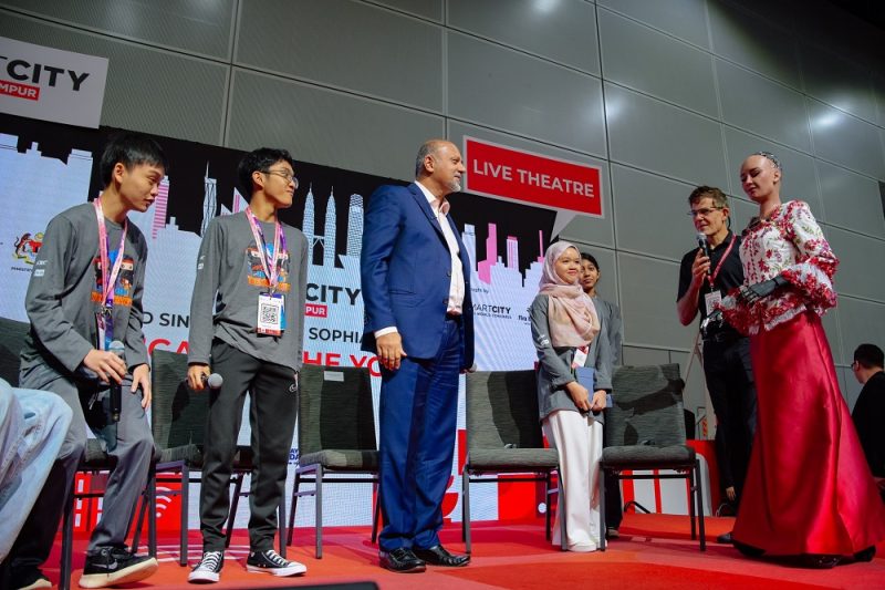 Sophia (far right) greeting Digital Minister Gobind Singh Deo and children at the Smart City Expo KL 2025 on Sept 19, 2025 at the Kuala Lumpur Convention Centre.
